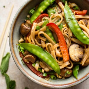 This vegan rice noodle stir fry is quick, easy, and loaded with veggies and bold flavors. The sauce is infused with ginger, garlic, soy sauce, hoisin sauce, and sriracha!