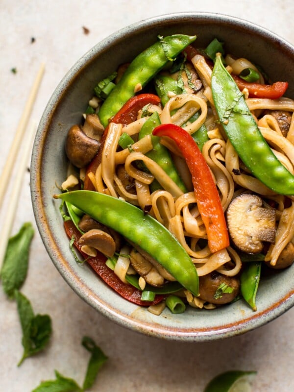 This vegan rice noodle stir fry is quick, easy, and loaded with veggies and bold flavors. The sauce is infused with ginger, garlic, soy sauce, hoisin sauce, and sriracha!