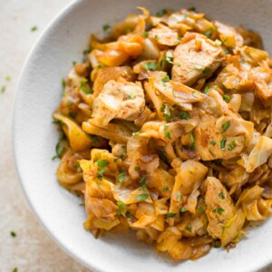 Sautéed cabbage and chicken is a healthy and delicious stir fry. Tender chicken breast, onions, and cabbage sautéed with garlic and paprika make a comforting family dinner! Delicious served with a dollop of sour cream!