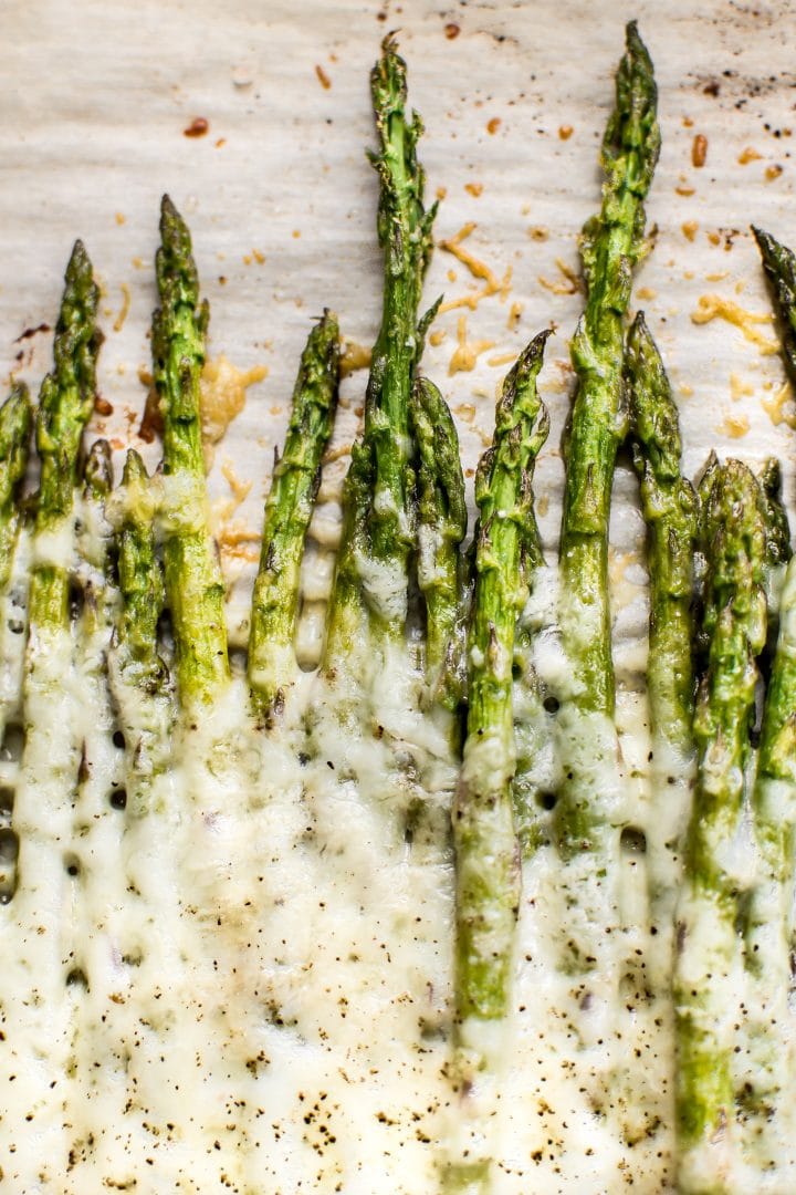 close-up of spears of low carb asparagus with melted cheese