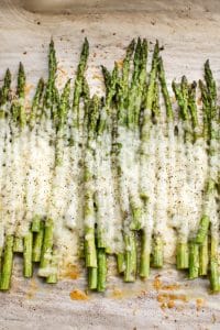 This easy cheesy baked asparagus recipe is the ultimate side dish! It only has a handful of everyday ingredients including parmesan, mozzarella, and garlic. This keto low carb recipe is a definite keeper!