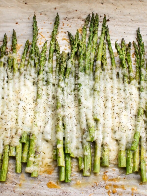 This easy cheesy baked asparagus recipe is the ultimate side dish! It only has a handful of everyday ingredients including parmesan, mozzarella, and garlic. This keto low carb recipe is a definite keeper!