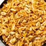 a skillet with chicken and cabbage stir fry