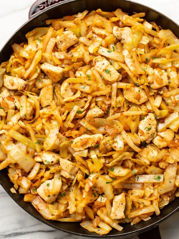 a skillet with chicken and cabbage stir fry