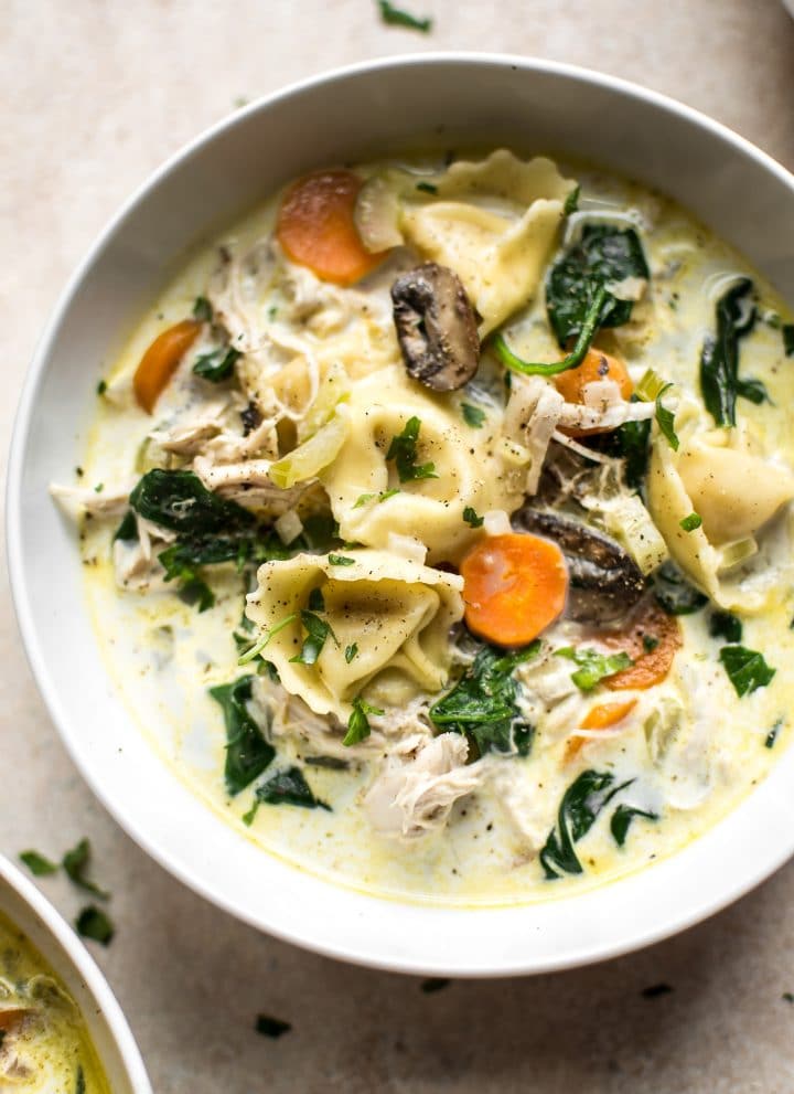 This easy creamy spinach tortellini soup is loaded with chicken, mushrooms, garlic, and carrots for amazing flavor that the whole family will love! 