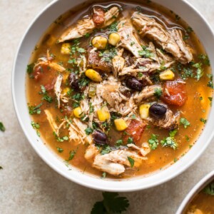 This easy Crockpot chipotle chicken soup is easy to make, spicy, and delicious! Corn, black beans, tender chicken, fire-roasted tomatoes, and chipotle chili peppers in adobo sauce make this one tasty soup.