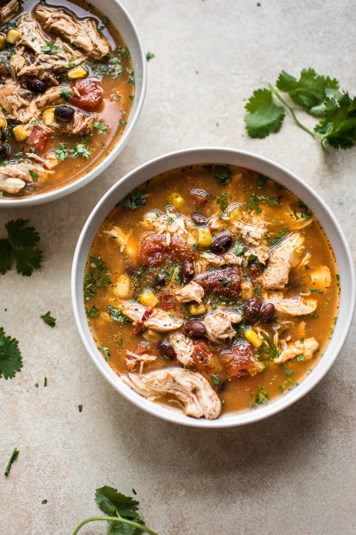 two white bowls with spicy chipotle chicken soup
