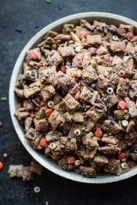 This Halloween puppy chow recipe is a fun, spooky, and perfect treat for October 31! Halloween sprinkles add the perfect twist to the classic chocolate, peanut butter, and powdered sugar snack.
