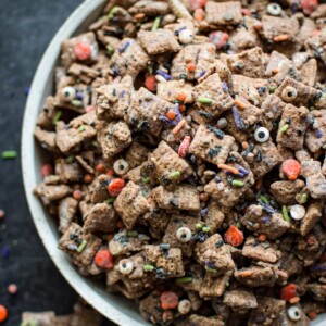 This Halloween puppy chow recipe is a fun, spooky, and perfect treat for October 31! Halloween sprinkles add the perfect twist to the classic chocolate, peanut butter, and powdered sugar snack.