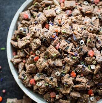 This Halloween puppy chow recipe is a fun, spooky, and perfect treat for October 31! Halloween sprinkles add the perfect twist to the classic chocolate, peanut butter, and powdered sugar snack.