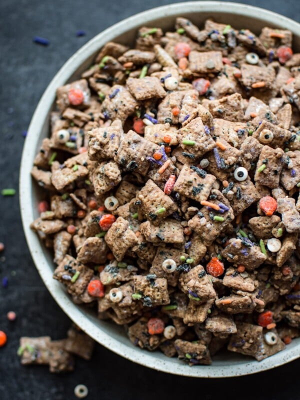 This Halloween puppy chow recipe is a fun, spooky, and perfect treat for October 31! Halloween sprinkles add the perfect twist to the classic chocolate, peanut butter, and powdered sugar snack.