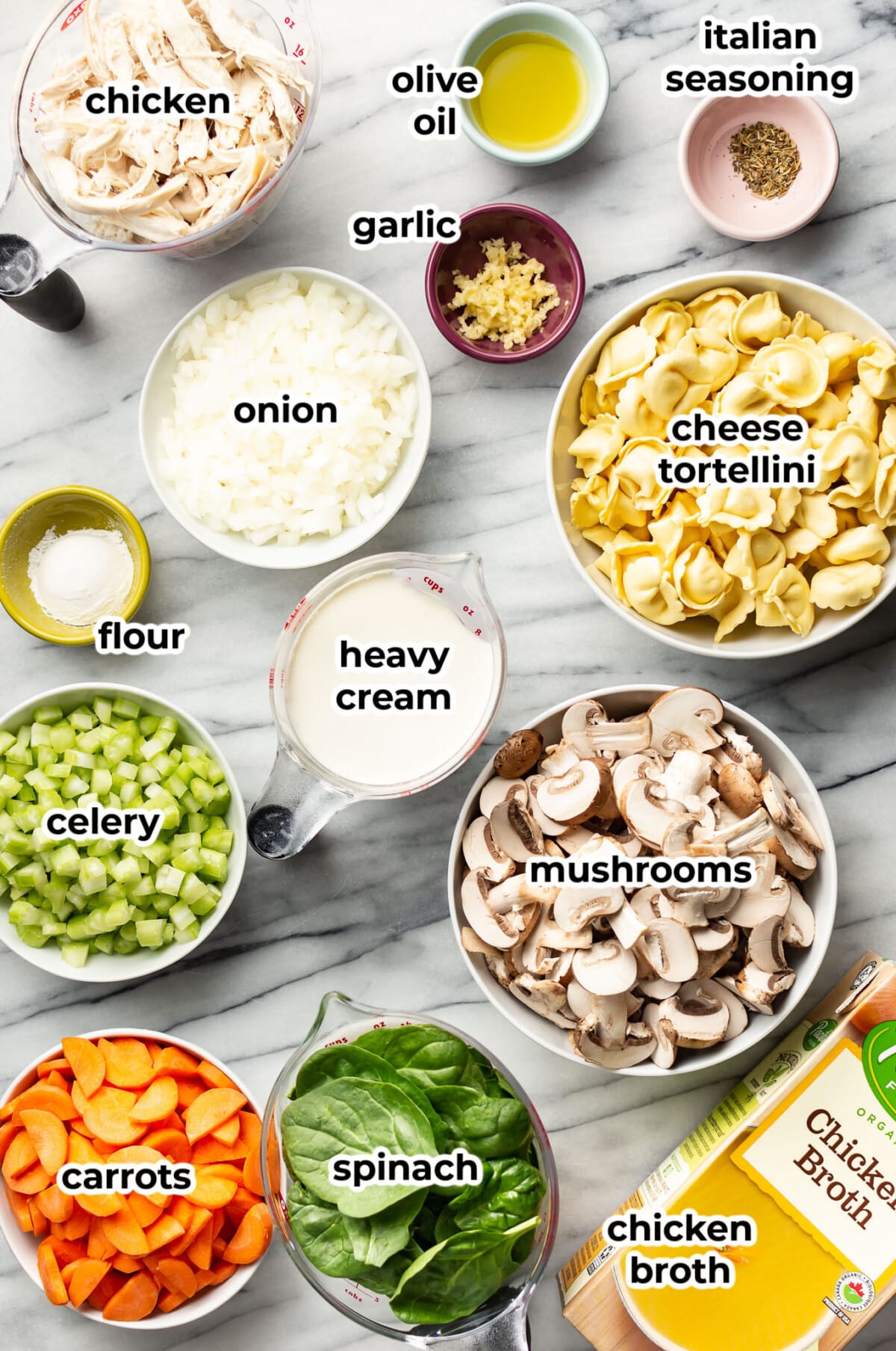 ingredients for creamy spinach tortellini chicken soup in prep bowls