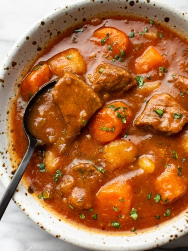 a bowl of instant pot beef stew with a spoon