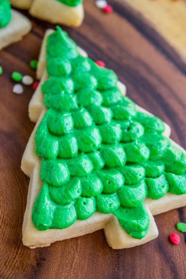 close-up of a soft sugar cookie in a christmas tree shape with green icing