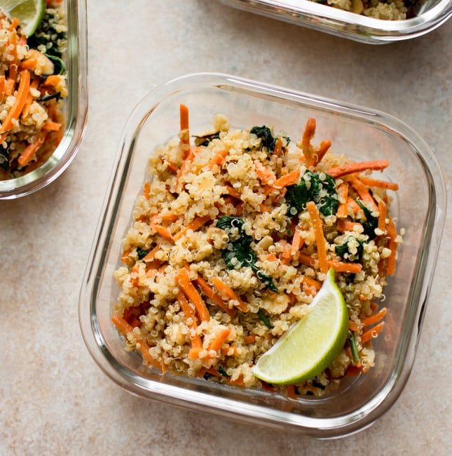 Want more plant based meals? These vegan meal prep bowls with spinach, carrots, quinoa, and a delicious light dressing are quick and easy. Great for meal prep beginners!