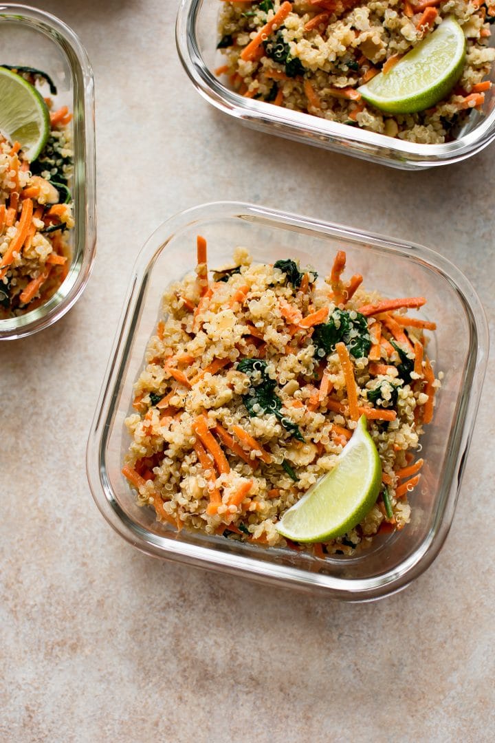 Want more plant based meals? These vegan meal prep bowls with spinach, carrots, quinoa, and a delicious light dressing are quick and easy. Great for meal prep beginners!