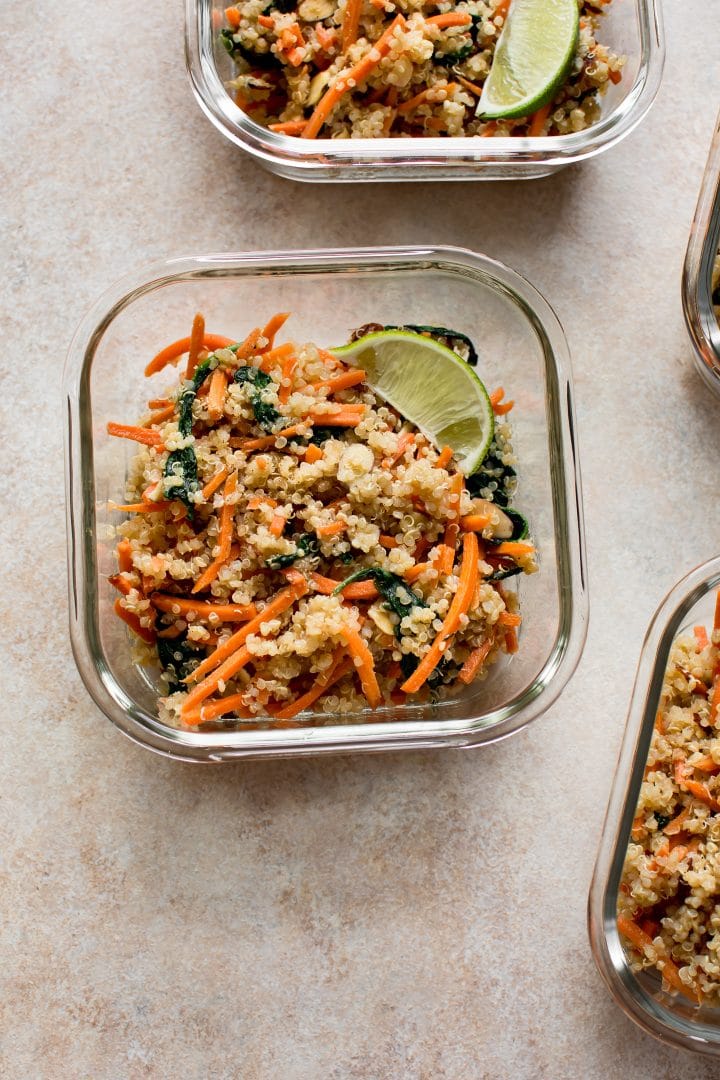 close-up of quinoa and spinach meal prep recipe in a glass container