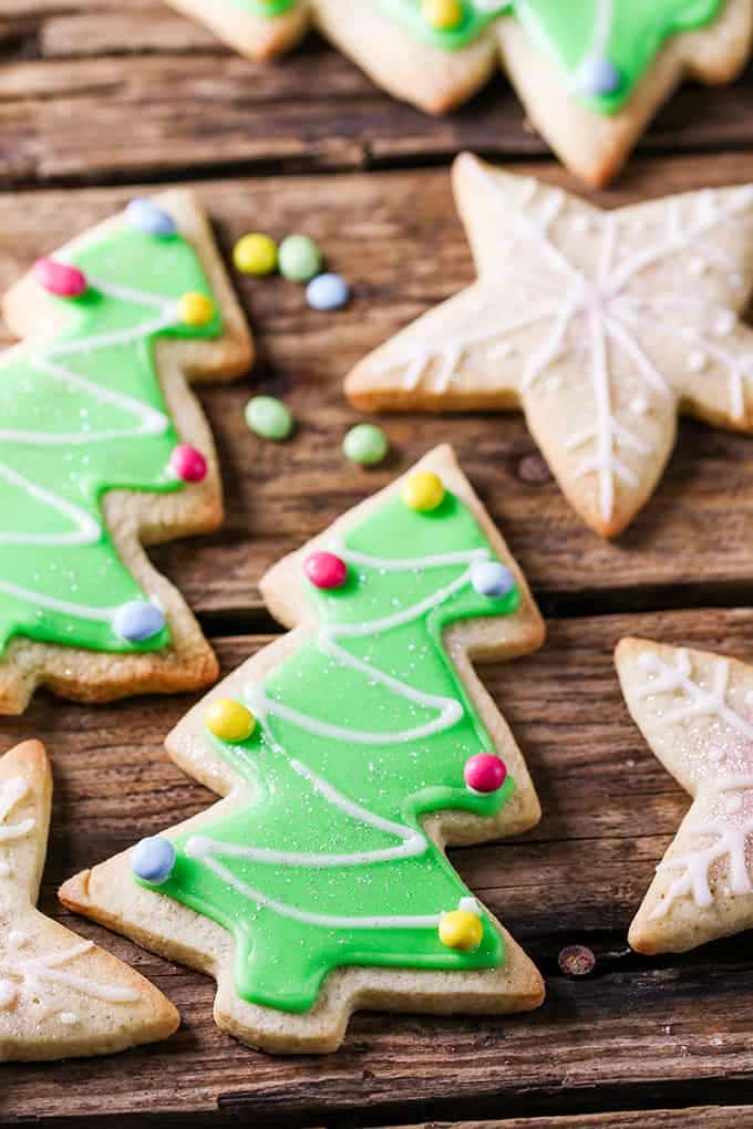 several sugar cookies with easy icing in star and tree shapes