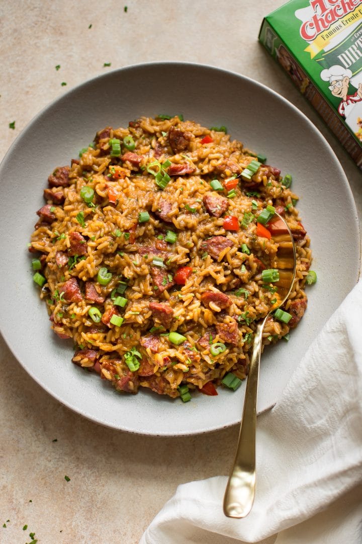 dirty rice dressing made with Tony Chachere's seasoning in a bowl with a serving spoon