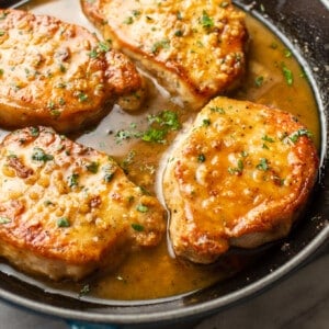 a skillet with honey soy sauce pork chops