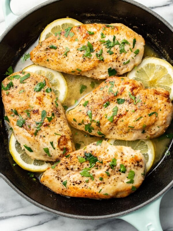 a skillet with lemon chicken