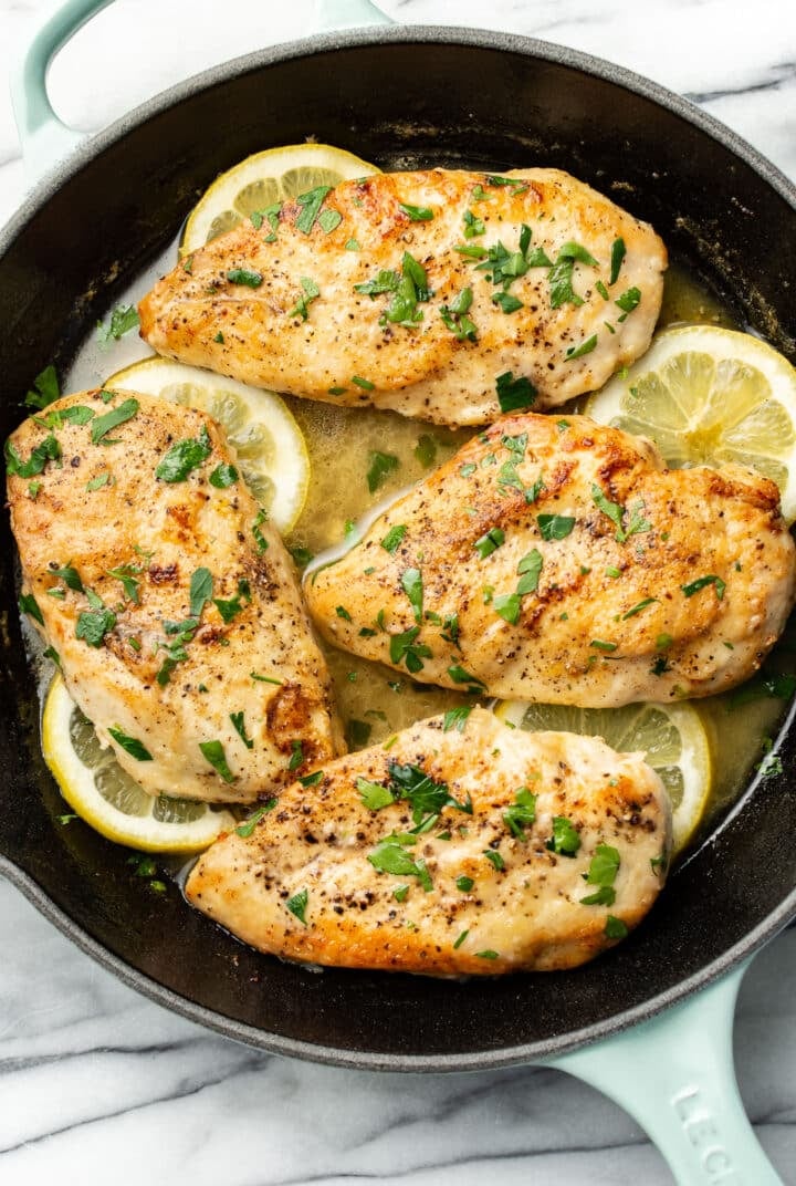 a skillet with lemon chicken