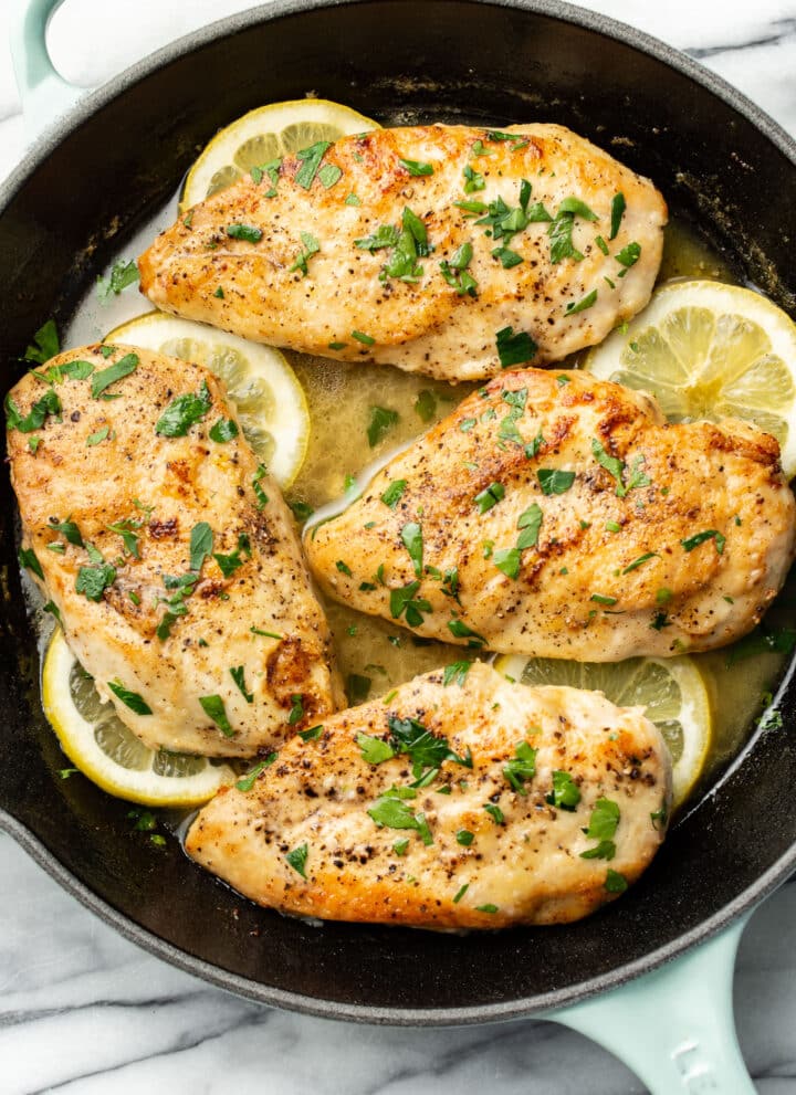 a skillet with lemon chicken