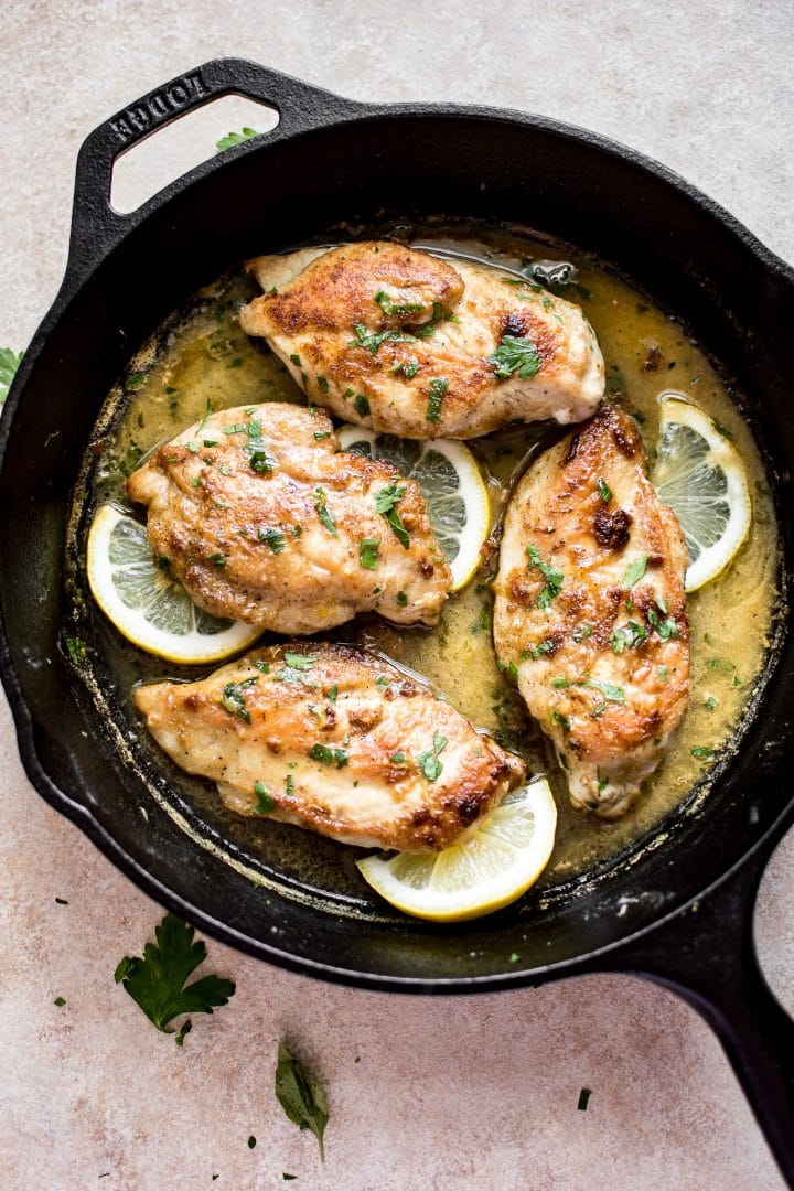 chicken in a cast iron skillet with a lemon butter sauce