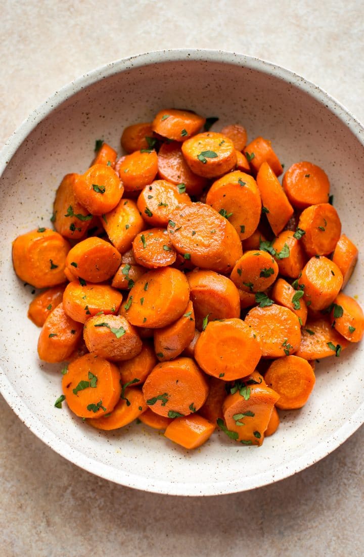 beige bowl of pieces of maple roasted carrots