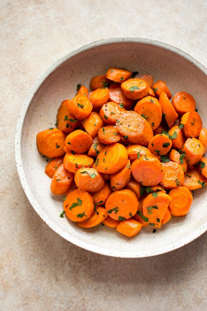 quick and easy maple glazed carrots in a beige bowl