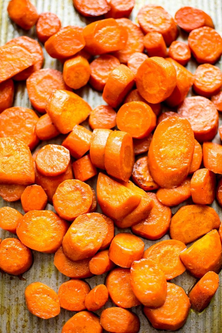 several pieces of sweet maple glazed carrots on a baking sheet
