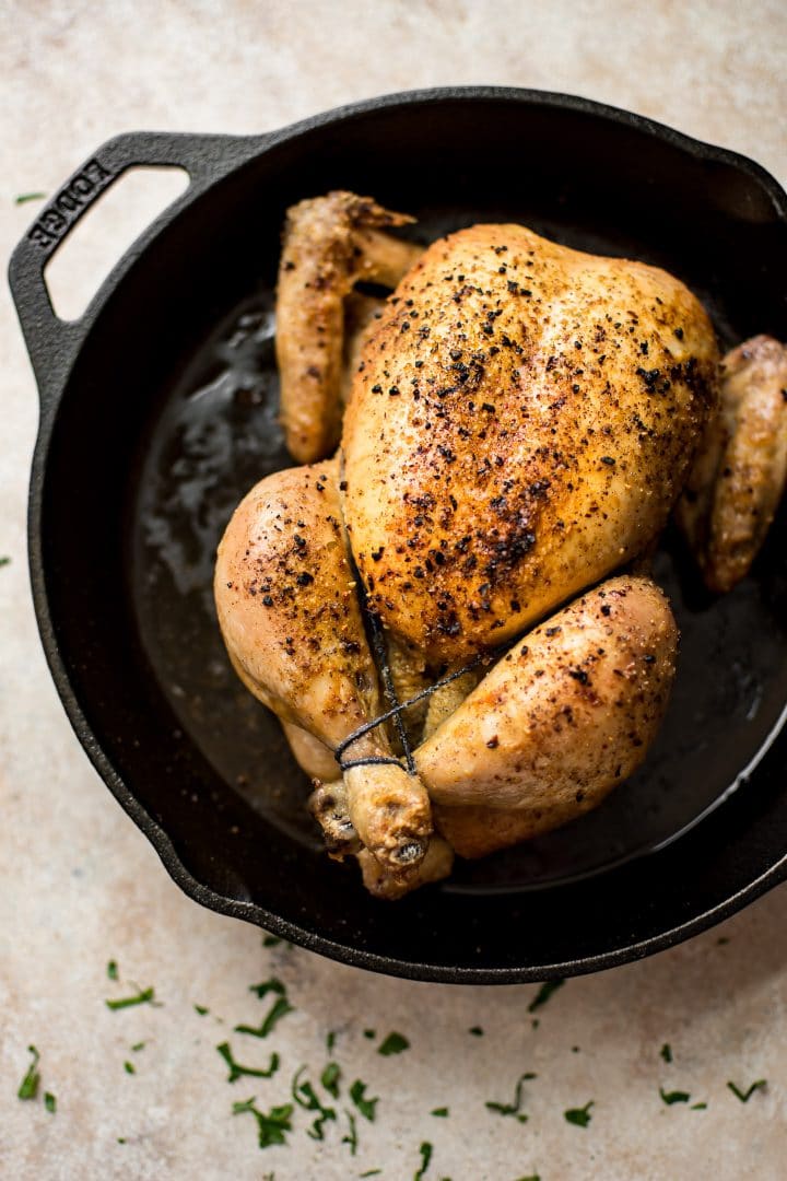 whole roast chicken in a cast iron skillet