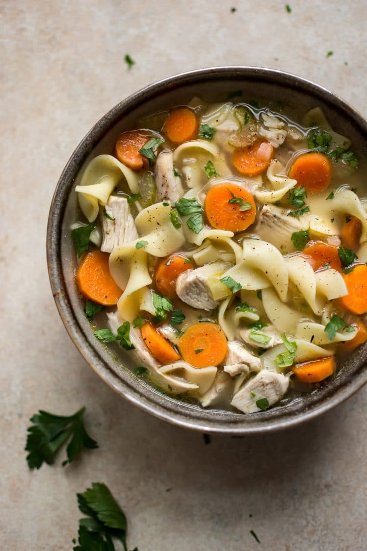 leftover turkey soup with egg noodles and carrots in a bowl