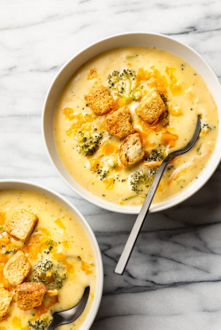 two bowls of broccoli cheddar soup