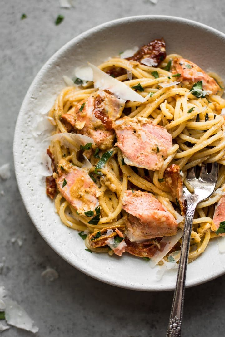 close-up of cream Cajun salmon pasta in a bowl with a fork
