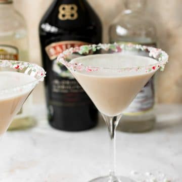 This Christmas cocktail recipe has Baileys, Creme de Cacao, Peppermint Schnapps, and a crushed candy cane rim. It's frothy and totally delicious!