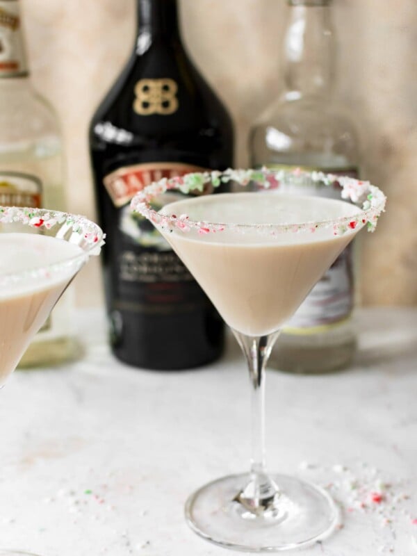 This Christmas cocktail recipe has Baileys, Creme de Cacao, Peppermint Schnapps, and a crushed candy cane rim. It's frothy and totally delicious!