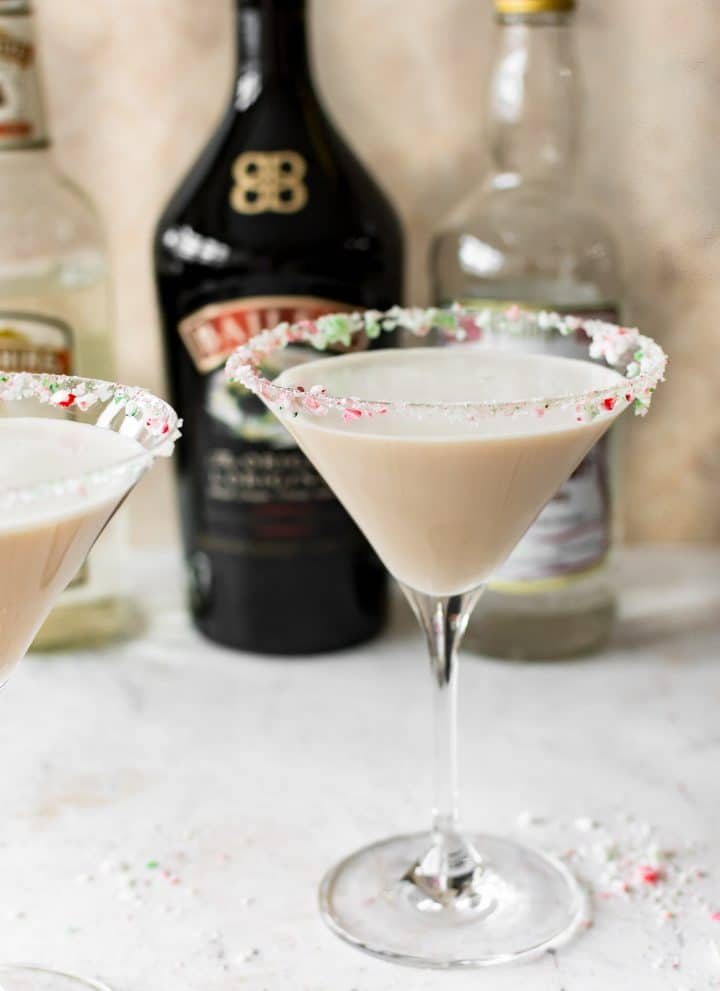 This Christmas cocktail recipe has Baileys, Creme de Cacao, Peppermint Schnapps, and a crushed candy cane rim. It's frothy and totally delicious!