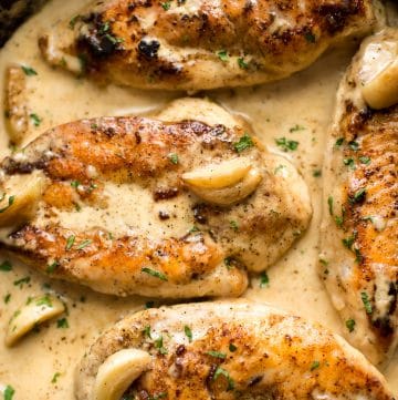 This creamy chicken skillet recipe is loaded with garlic and the the most amazing melt-in-your-mouth chicken. Make it for dinner tonight!