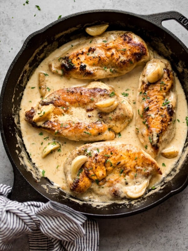 This easy creamy garlic chicken is a simple and incredibly delicious weeknight meal. The creamy garlic sauce with whole cloves of garlic will have you going back for seconds!