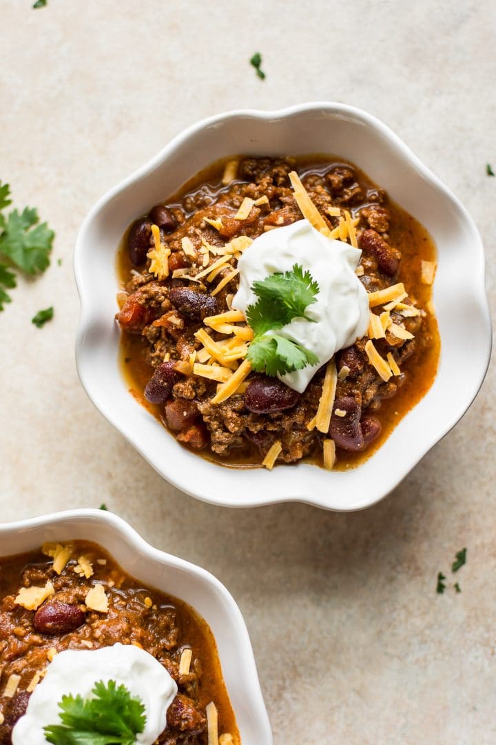 white bowl with healthy and delicious Instant Pot chili recipe with beef, beans, tomatoes, and a spice blend