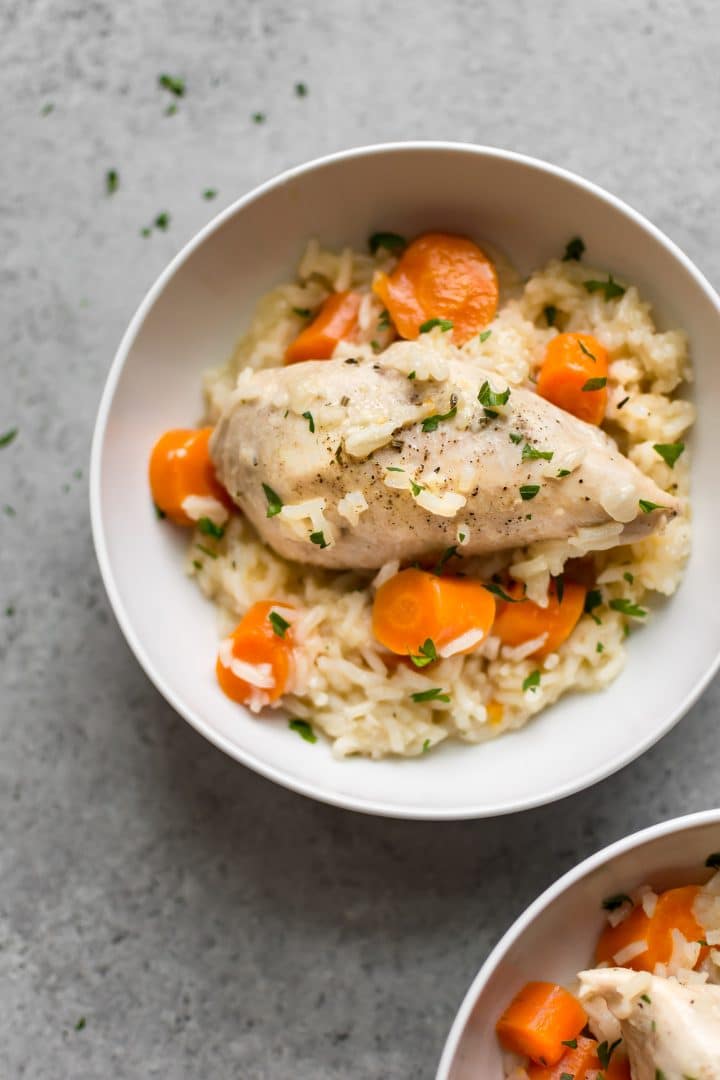 white bowl with simple Instant Pot lemon chicken and creamy rice and carrots