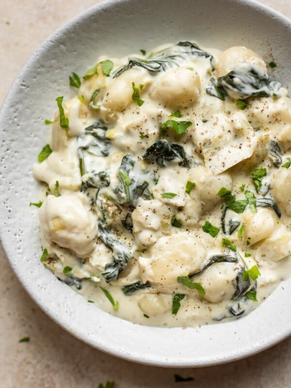 Creamy spinach and artichoke gnocchi is made in one pan, can be made vegetarian, and makes the most delicious comfort food side dish!