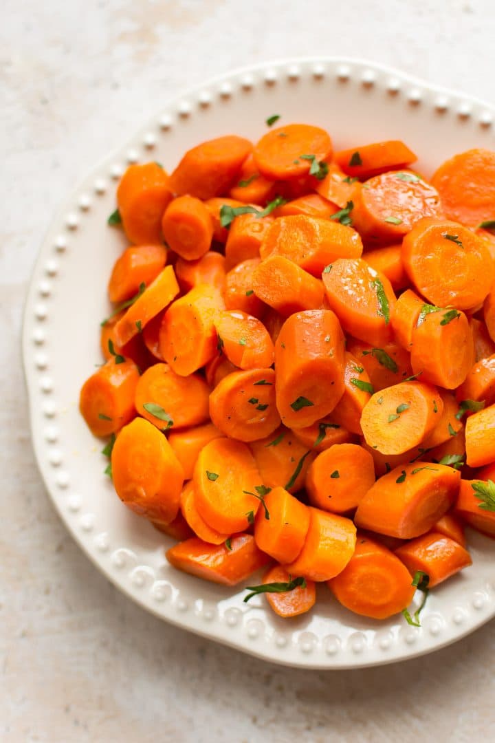 close-up of slow cooker honey glazed carrots on a white plate