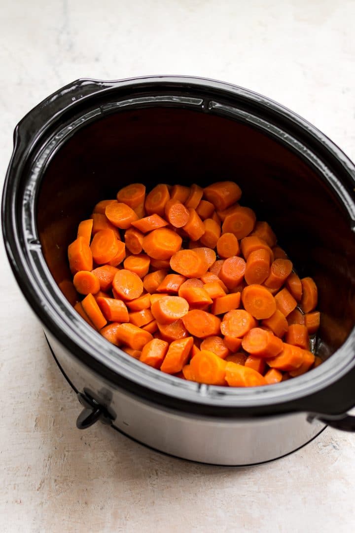 close-up of sliced carrots inside a Crockpot slow cooker