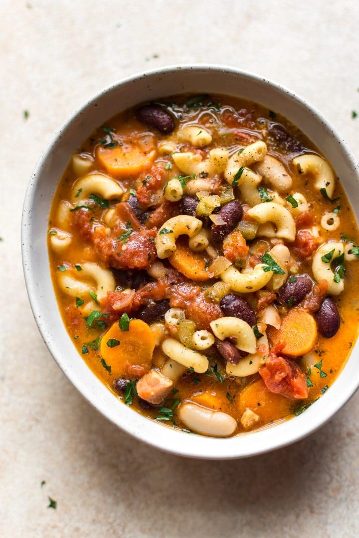 authentic homemade pasta e fagioli soup with pasta, beans, veggies, and pancetta in a white bowl