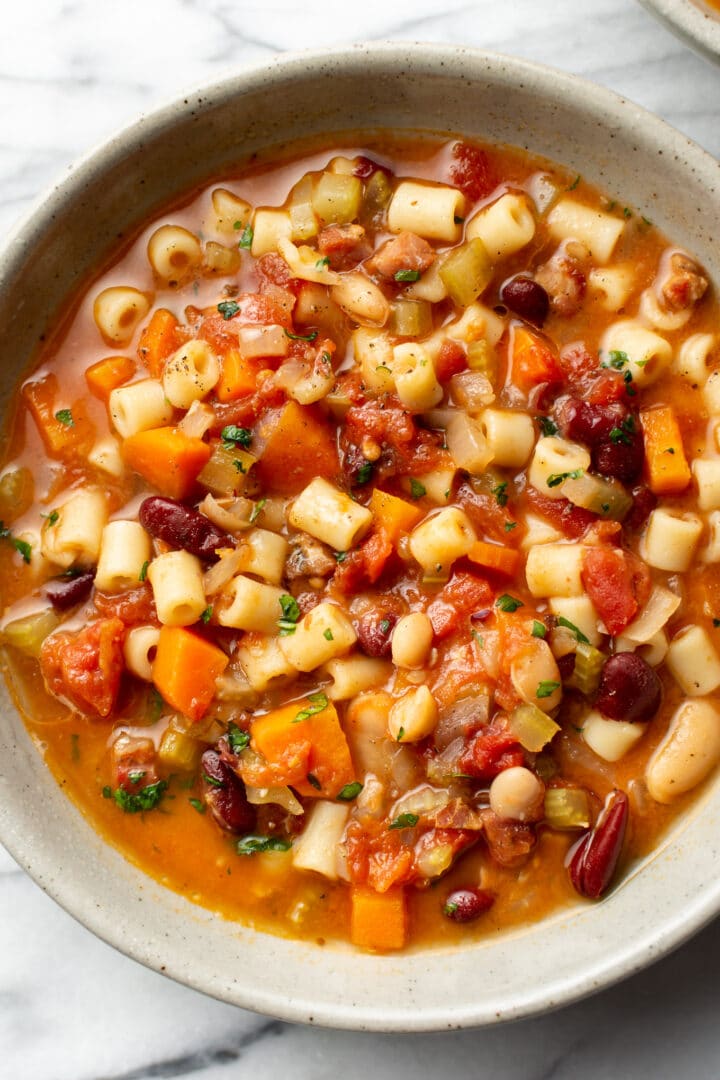 pasta e fagioli soup in a bowl on a marble surface