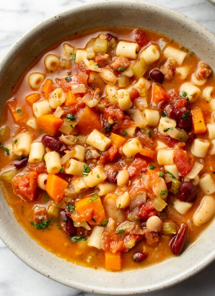 pasta e fagioli soup in a bowl on a marble surface