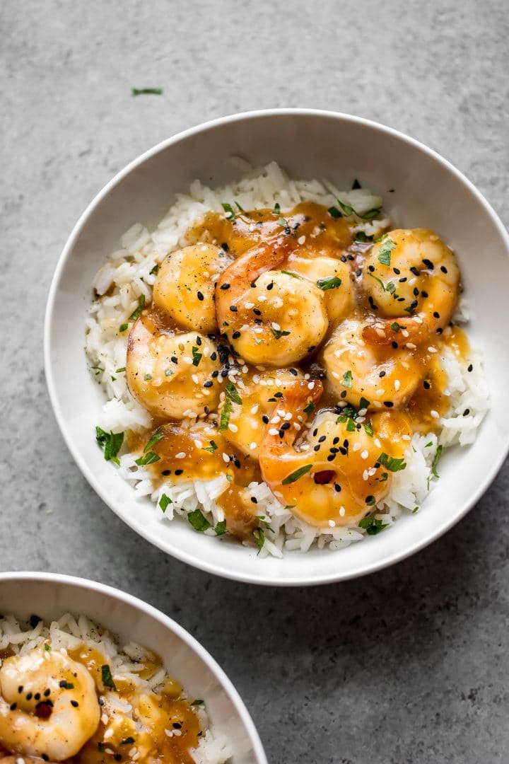 white bowl with easy sesame ginger shrimp over rice