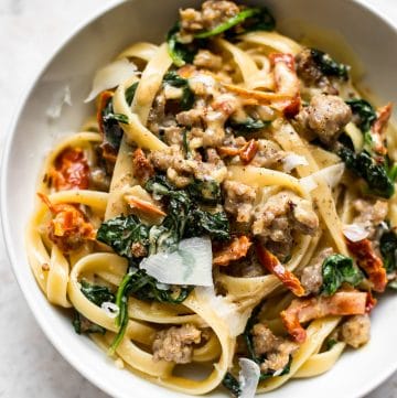 This creamy Tuscan sausage pasta is loaded with the good stuff like garlic, sun-dried tomatoes, spinach, basil, lemon, and Italian sausage. The sauce is amazing and you'll want seconds!